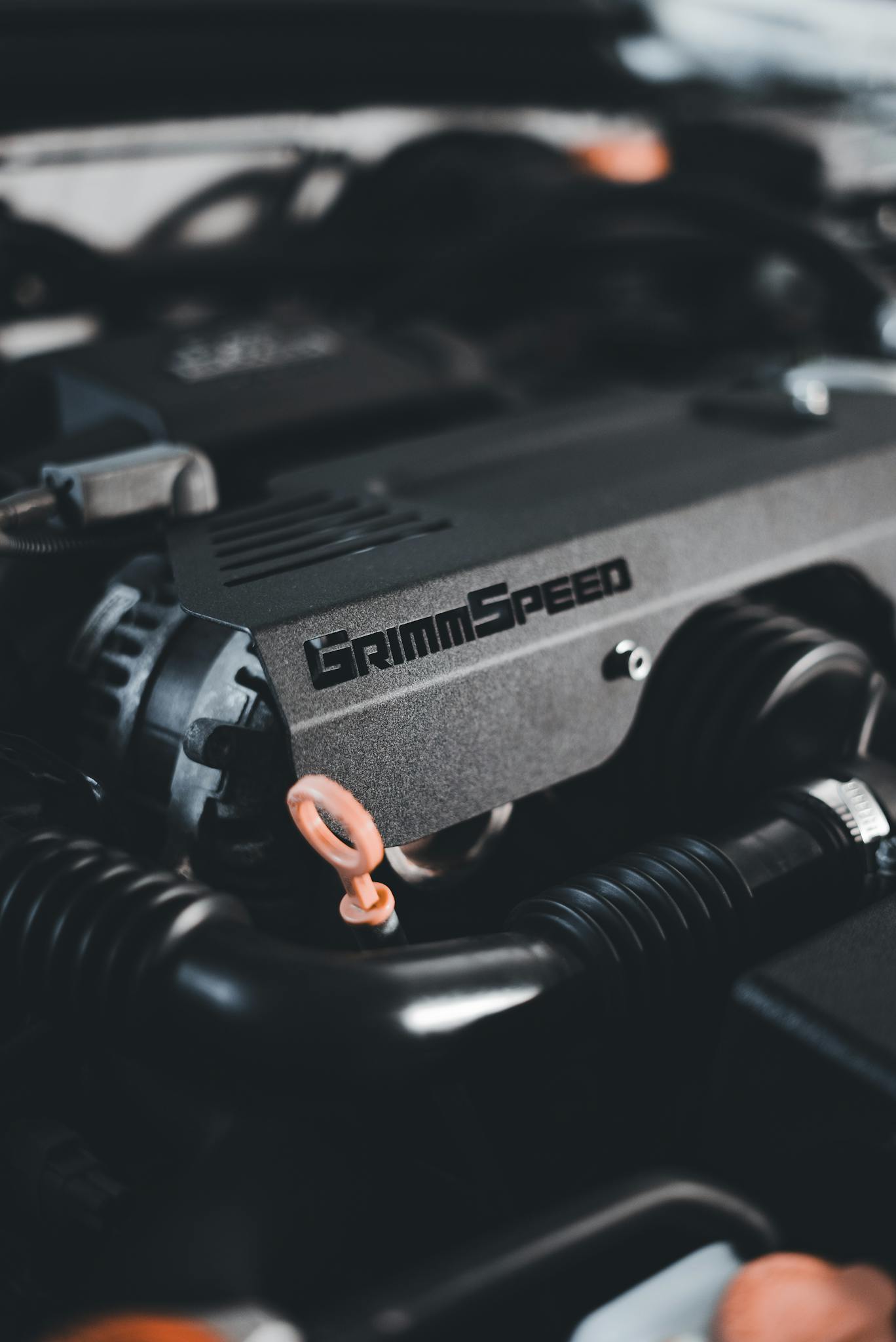 Detailed shot of a GrimmSpeed car engine part with focus on the branding.